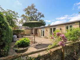 An outdoor patio with a table and chairs at Meadow Lodge Cerney Wick near South Cerney Cotswolds