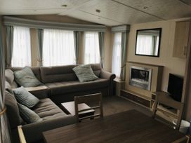 A living room with a sofa and a table at Swanage Bay View in Swanage