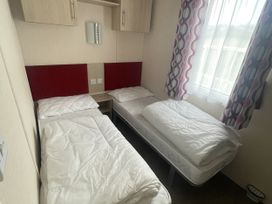 A bedroom with three single beds at Swanage Bay View in Swanage