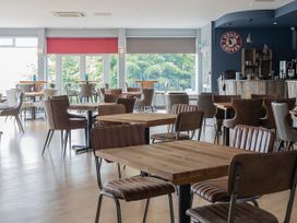 A dining room with tables and chairs at Swanage Bay View in Swanage