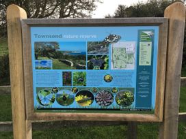 An information board about Townsend nature reserve with a map and images of wildlife in Swanage Bay View Swanage