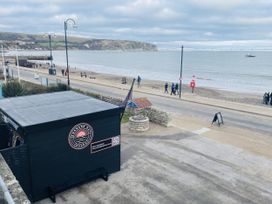 A seaside view with a building and beach at Swanage Bay View in Swanage