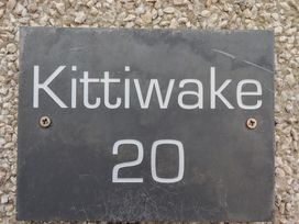 A nameplate with Kittiwake 20 on it at Kittiwake at No 20 Seahouses