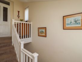A stairwell featuring a staircase and framed pictures at Kittiwake at No 20 Seahouses