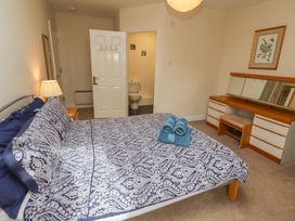 A bedroom with a bed and dresser at Kittiwake at No 20 Seahouses