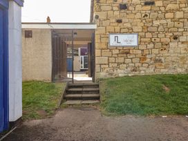 An entrance with steps and a stone wall at Kittiwake at No 20 Seahouses