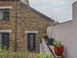 An exterior view of a stone wall and planters at The Annex At The Barn in Pelynt
