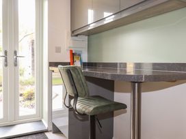 A kitchen with a bar stool and counter at The Annex At The Barn in Pelynt
