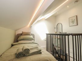 A bedroom with a bed and towels at The Annex At The Barn in Pelynt