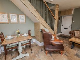 A dining area with a table and chairs at Ingleside Cottage in Whitby