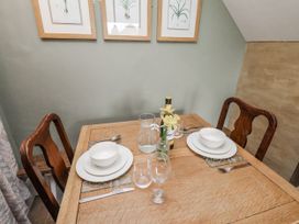A dining room with a table set for two at Ingleside Cottage in Whitby