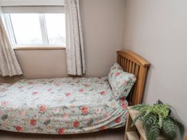 A bedroom with a bed and a window at Ingleside Cottage in Whitby
