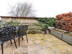A patio area with chairs and a table at Ingleside Cottage in Whitby