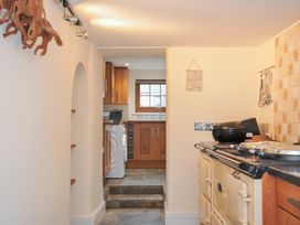 A kitchen with an oven, sink, and washing machine at Little Blagdon in Beaworthy