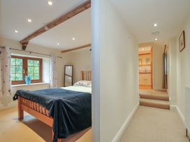 A bedroom with a bed and a mirror at Little Blagdon in Beaworthy