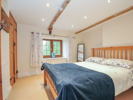 A bedroom with a bed and window at Little Blagdon in Beaworthy