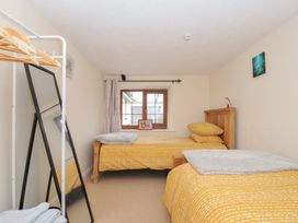 A bedroom with two beds and a window at Little Blagdon in Beaworthy