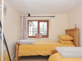 A bedroom with two beds and a window at Little Blagdon in Beaworthy
