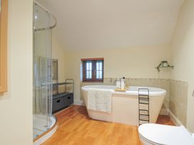 A bathroom with a bathtub and shower at Little Blagdon Beaworthy