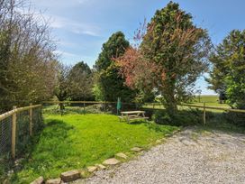 A garden with a picnic table and trees at Little Blagdon Ashwater