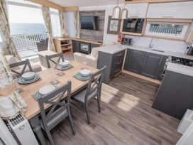 A kitchen with a dining area at Devon Cliffs Holiday Park - Holiday Accommodation 14142, Exmouth