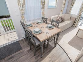 A dining area with a table set for meals at Devon Cliffs Holiday Park - Holiday Accommodation 14142, Exmouth