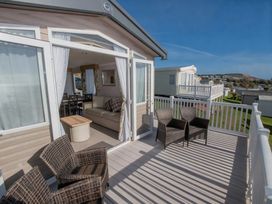 An outdoor terrace with seating and table at Devon Cliffs Holiday Park - Holiday Accommodation 14142, Exmouth