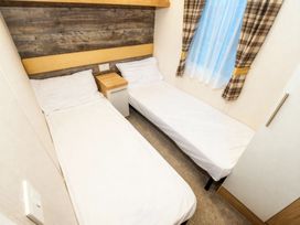 A bedroom with two beds and a window at Devon Cliffs Holiday Park - Holiday Accommodation 14142, Exmouth