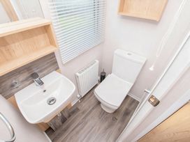 A bathroom with a sink and toilet at Devon Cliffs Holiday Park - Holiday Accommodation 14142 Exmouth