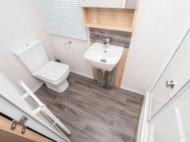 A bathroom with a toilet and sink at Devon Cliffs Holiday Park - Holiday Accommodation 14142, Exmouth