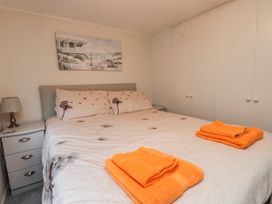 A bedroom with a bed and towels on top at Lodge 134 Lon Bryn Mair near Bellech