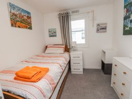A bedroom with a bed and nightstand at Lodge 134 Lon Bryn Mair near Bellech