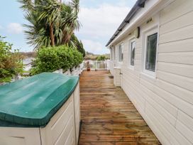 An outdoor area with decking and a shed at Lodge 134 near Bellech