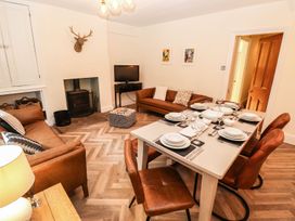 A dining room with a table set for meals at Waterhead Cottage in Ambleside