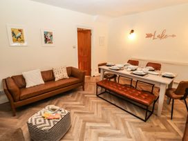 A dining room with a table set for a meal at Waterhead Cottage in Ambleside