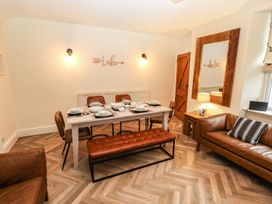 A dining room with a table set for meals at Waterhead Cottage in Ambleside
