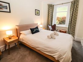 A bedroom with a bed and bedside tables at Waterhead Cottage in Ambleside