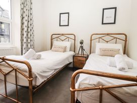 A bedroom with two single beds and a nightstand at Waterhead Cottage in Ambleside