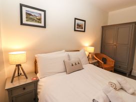 A bedroom with a bed and lamp at Waterhead Cottage in Ambleside