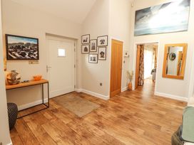 A hallway with a table and photographs at Lakes View in Keswick