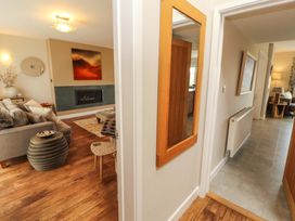 A living room with a fireplace and a sofa at Lakes View in Keswick