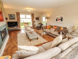 A living room with a sofa and television at Lakes View in Keswick
