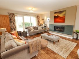 A living room with sofas and a fireplace at Lakes View in Keswick