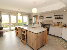 A kitchen with an island and stools at Lakes View in Keswick