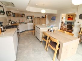 A kitchen with a table and chairs at Lakes View in Keswick