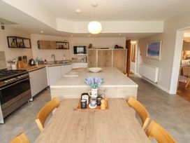 A kitchen with a table and chairs at Lakes View in Keswick