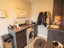 A laundry room with a washing machine and sink at Lakes View in Keswick