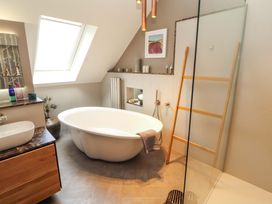 A bathroom with a bathtub and sink at Lakes View in Keswick