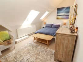 A bedroom with a bed and bedside table at Lakes View in Keswick