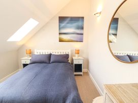 A bedroom with a bed and nightstands at Lakes View in Keswick